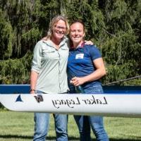 GVSU mother and daughter alumni Mandy Boersen and Audrey Boersen hugging behind boat that says Laker Legacy